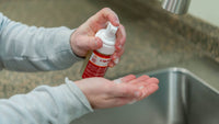 Someone washing their hands in a sink with Almond Goat Milk Liquid Soap Foamer