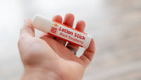 Someone holding a Black Raspberry Goat Milk Lotion Stick