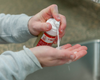 Applying goat milk liquid soap to hands using a foamer bottle