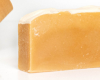 A yellow bar of soap with a white background