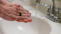 Someone washing his hands in the sink
