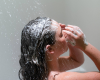 Indigo lathering shampoo into her hair