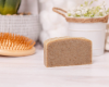 shampoo bar sitting on wood surface with hairbrush and plant in background