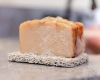 natural bar of soap lathered on a soap rest