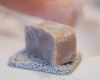 brown mega size bar of soap sitting on soap rest
