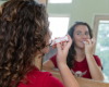 woman applying Goat Milk Stuff lip balm