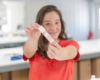 Child holding a Goat Milk Stuff lip balm.