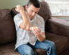 Man applying large solid goat milk lotion to his elbow