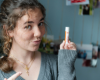 Indigo holding the lip balm in her hand