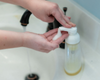using foamer bottle to pump liquid goat milk soap foam into hands