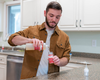 Greyden refilling the foamer bottle with liquid soap
