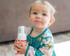 Baby holding the goat milk liquid soap