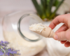 scooping milk bath soap shreds with wood scoop