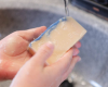 washing hands with white bar of soap with a blue swirl on top