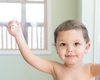 Landon holding a small spray bottle of perfume