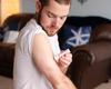 Applying small lotion stick to arms