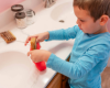Landon putting a bar of goat milk soap into a Soap Saver