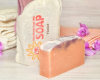 Bar of goat milk soap with floral background