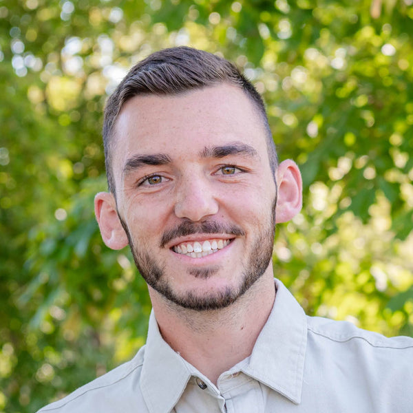 Man smiling with trees in background