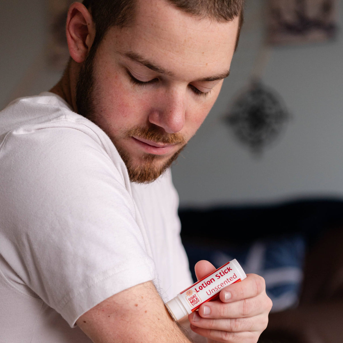 Man applying Goat Milk Stuff Small Lotion to his arm.