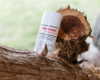 Goat Milk deodorant placed on a tree branch outdoors