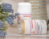 Two Goat Milk Deodorant displayed beside a purple flower