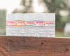 Five Goat Milk Deodorants displayed outdoors on top of a wooden surface