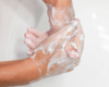 washing hands using goat milk soap
