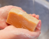 washing hands with yellow bar of soap