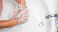 Washing hands in the sink using Goat Milk Soap
