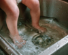 Washing a child’s feet in a sink using goat milk liquid soap