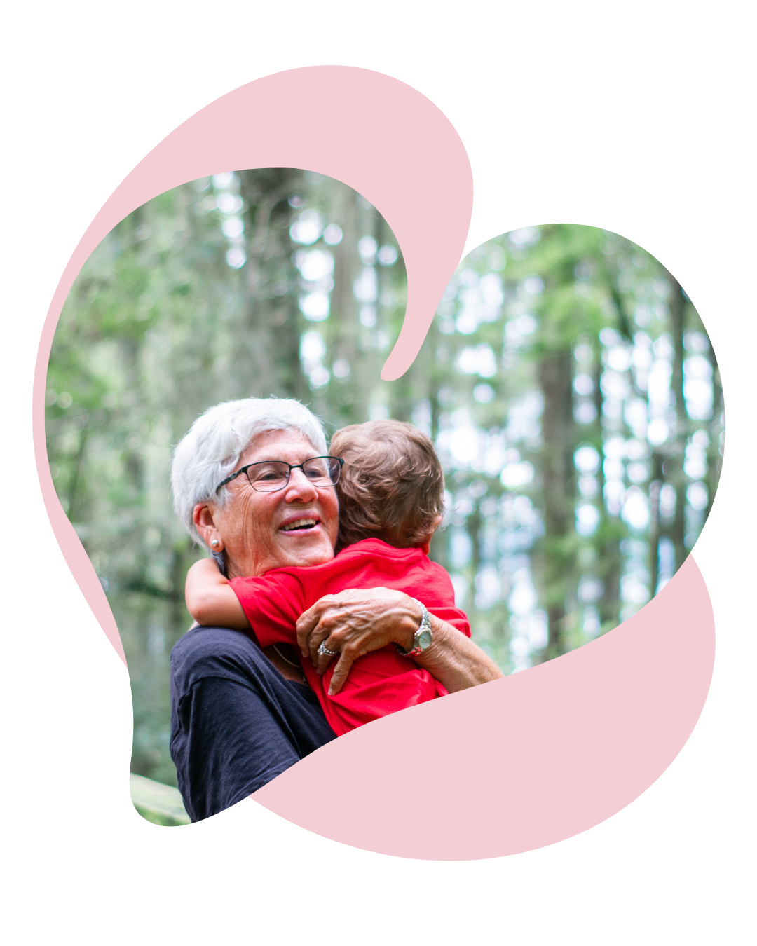 An older woman smiling while hugging a young child outdoors