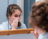 Indigo washing her face in mirror with natural soap