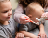 Indigo helping Landon and Michael apply Tooth Powder to a toothbrush