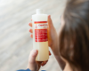 Person holding a bottle of Goat Milk Stuff liquid soap