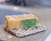 yellow goat milk soap bar with green swirl on Soap Rest