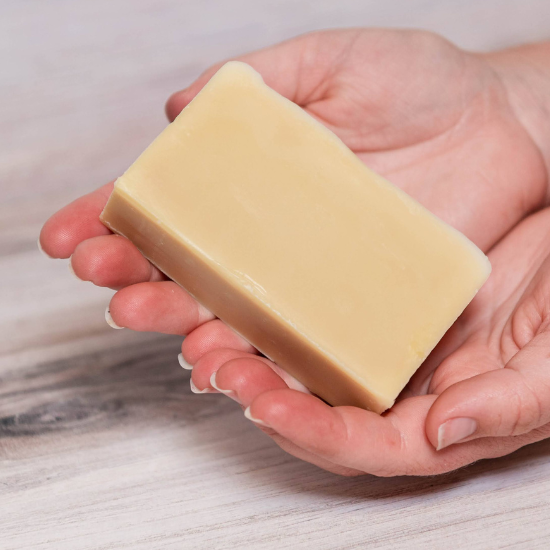 holding bar of goat milk soap for naturally soft skin