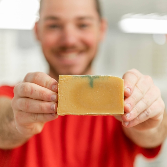 Fletcher holding bar of goat milk soap