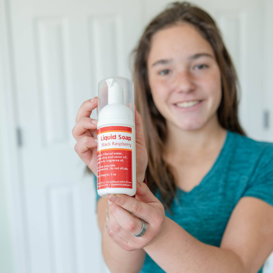 Jade holding liquid goat milk soap foamer bottle