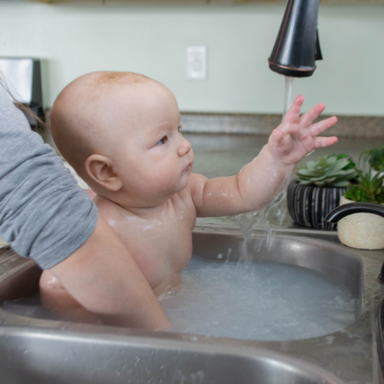 washing baby Michael in sink with goat milk soap