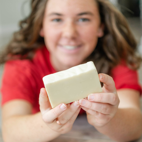 Indigo holding the Castille Goat Milk Soap 
