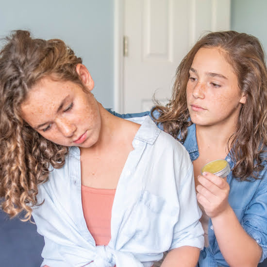 jade applying goat balm with arnica to indigo's neck