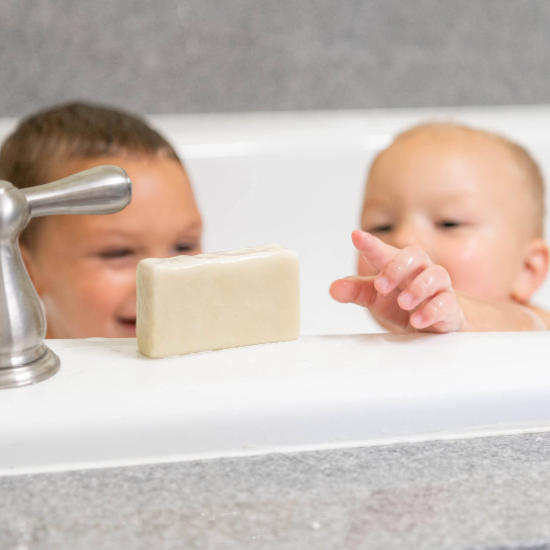 Landon and Michael in bath tub with goat milk soap
