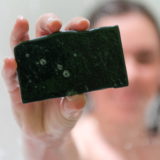 Woman holding the Activated Bamboo Charcoal Goat Milk Soap
