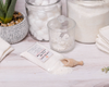 Laundry Standard Goat Milk Soap spilling out of bag onto table with wood scoop