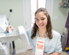 Jade holding the Goat Milk Laundry Soap in the laundry room