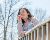 Indigo leaning against deck railing using lip balm
