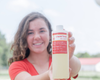 Indigo holding a goat milk soap refill.