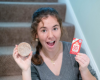 Indigo holding a luffa soap and a Goat Milk Stuff soap card 