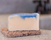 white bar with blue swirl sitting on tan soap rest